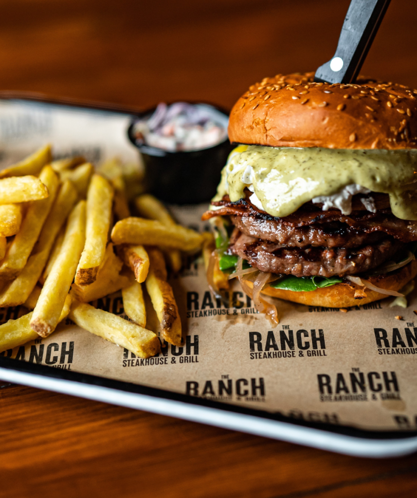 Restaurant tray lined with custom Ranch-branded paper holding a burger and fries
